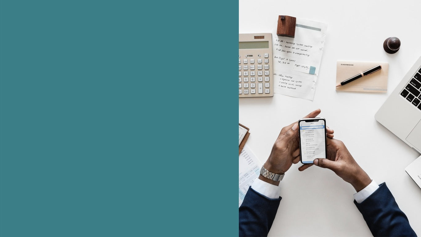 Business planning desk with a phone, calculator, notebook and laptop