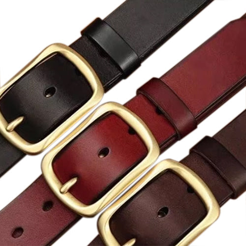 Close-up of black, red and brown belts with brass-coloured buckles